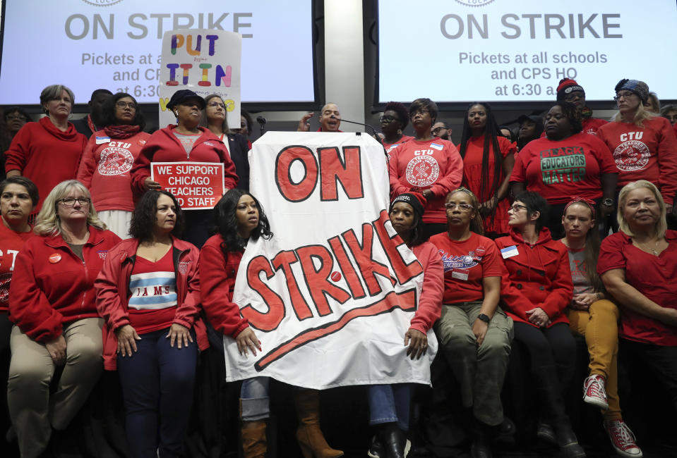 Teacher Jesse McAdoo addresses reporters while surrounded by fellow teachers after a meeting of the Chicago Teachers Union House of Delegates at the CTU Center, Wednesday, Oct. 16, 2019, in Chicago. Chicago parents and community groups are scrambling to prepare for a massive teachers' strike set to begin Thursday, prompting the city to preemptively cancel classes in the nation's third-largest school district. (John J. Kim/Chicago Tribune via AP)