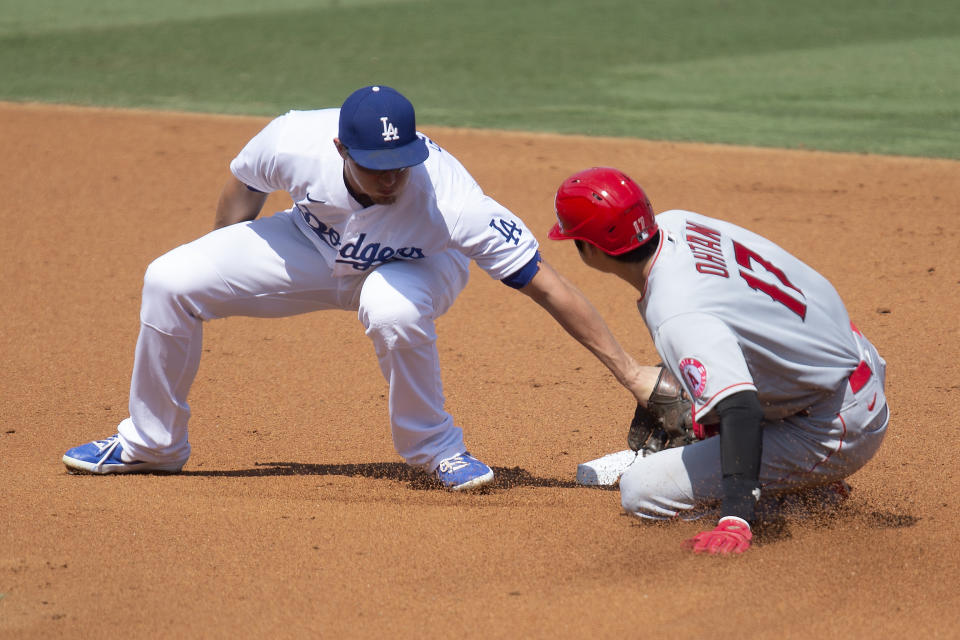 Los Angeles Dodgers shortstop Corey Seager, left, tags out Los Angeles Angels' Shohei Ohtani from stealing second base during the second inning of a baseball game in Los Angeles, Sunday, Sept. 27, 2020. (AP Photo/Kyusung Gong)