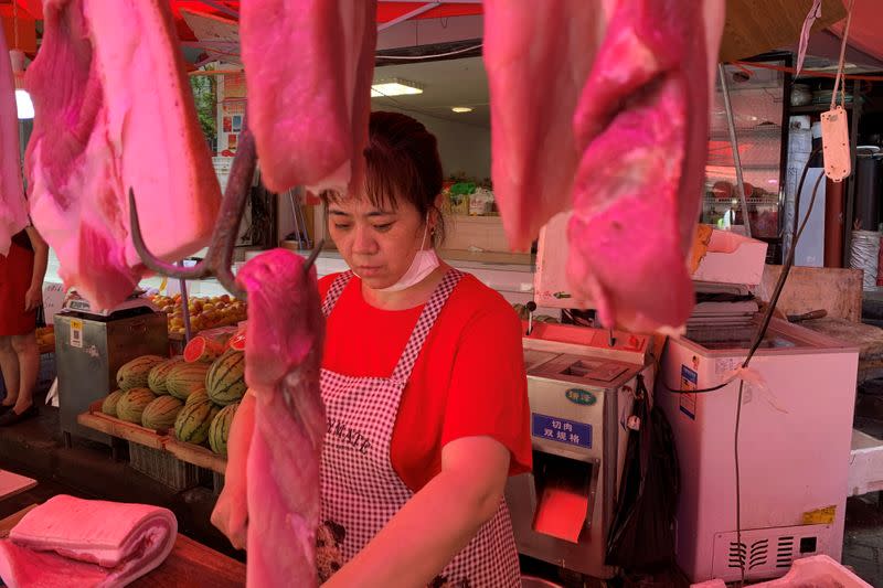 Vendor is seen at a pork stall at a market following the coronavirus disease (COVID-19) outbreak in Wuhan