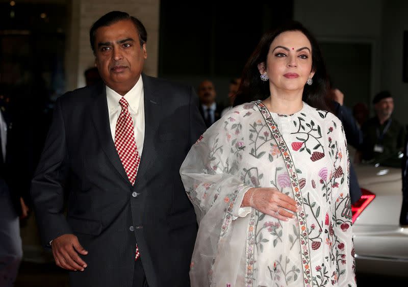 FILE PHOTO: Mukesh Ambani, Chairman and Managing Director of Reliance Industries, arrives with his wife Nita Ambani to address the company's annual general meeting in Mumbai