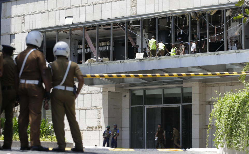 Police and forensic officials inspect a blast spot at the Shangri-la hotel in Colombo, Sri Lanka, Sunday, April 21, 2019. More than hundred people were killed and hundreds more hospitalized from injuries in near simultaneous blasts that rocked three churches and three luxury hotels in Sri Lanka on Easter Sunday, a security official told The Associated Press, in the biggest violence in the South Asian country since its civil war ended a decade ago.(AP Photo/Eranga Jayawardena)