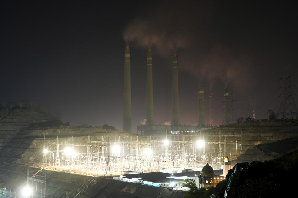 Steams spew from the chimneys of a coal power plant, in Cilegon, Banten province, Indonesia, on Oct. 3, 2023. Pollution is causing respiratory illnesses and deaths to rise in Indonesia's island of Java, including the capital, Jakarta. Data gathered by IQAir, a Swiss air technology company, regularly ranks Jakarta as one of the most polluted cities in the world. Blue skies are a rare sight and the air often smells like fuel or heavy smoke.(AP Photo/Achmad Ibrahim)