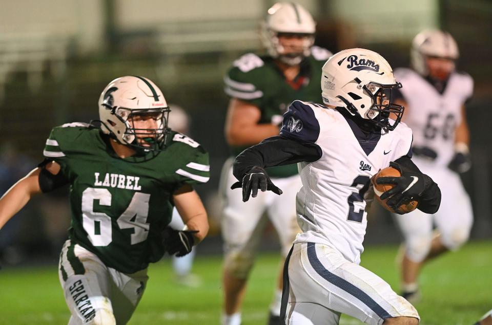 Rochester's Jerome Mullins (2) carries the ball during Friday night's game at Laurel.