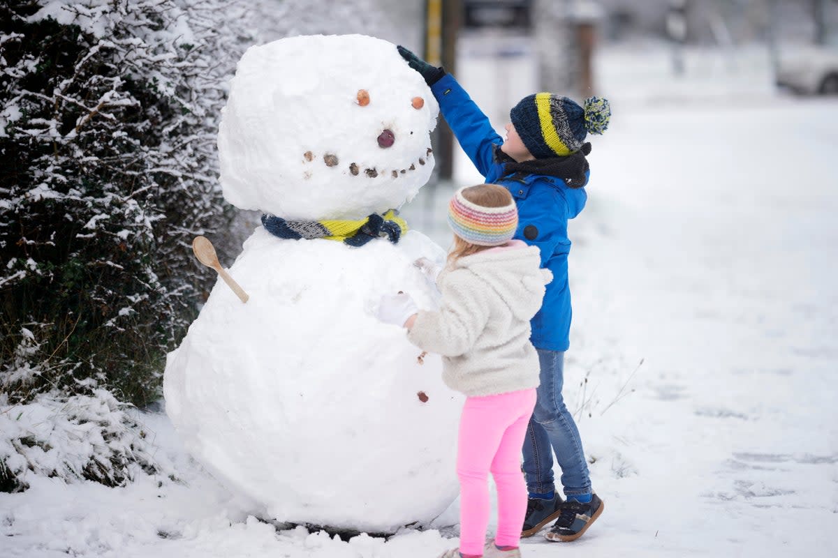 Children build a snowman after the first significant snow fall in Cheshire this winter in Northwich, United Kingdom (Getty)