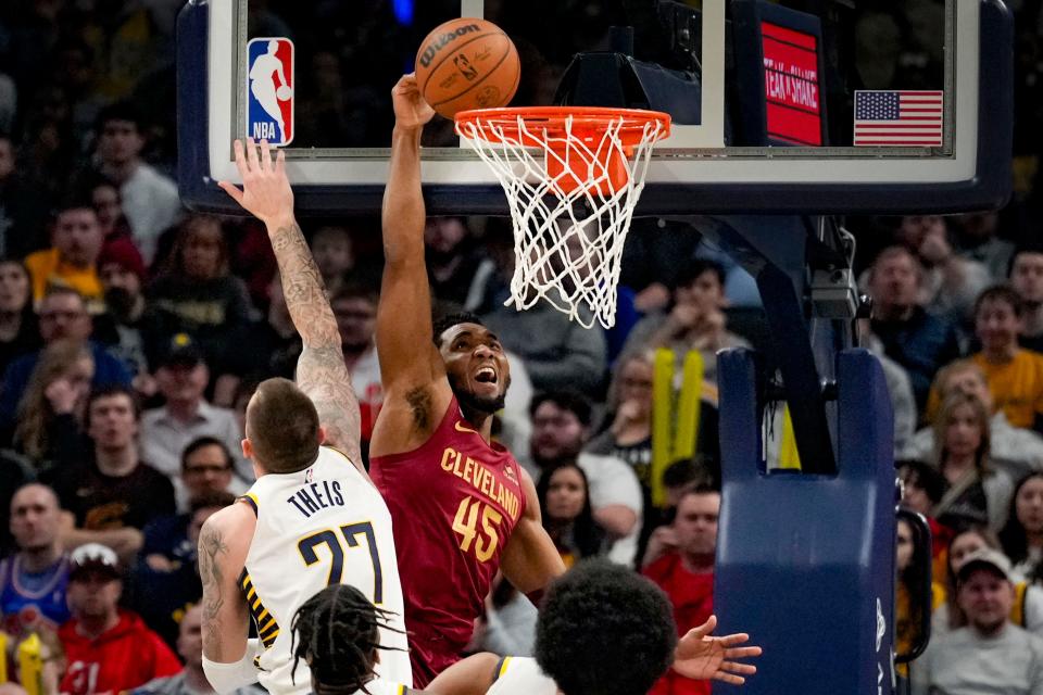 Cleveland Cavaliers guard Donovan Mitchell (45) tries to dunk but misses in front of Indiana Pacers center Daniel Theis (27) during the second half of an NBA basketball game in Indianapolis, Sunday, Feb. 5, 2023. (AP Photo/AJ Mast)