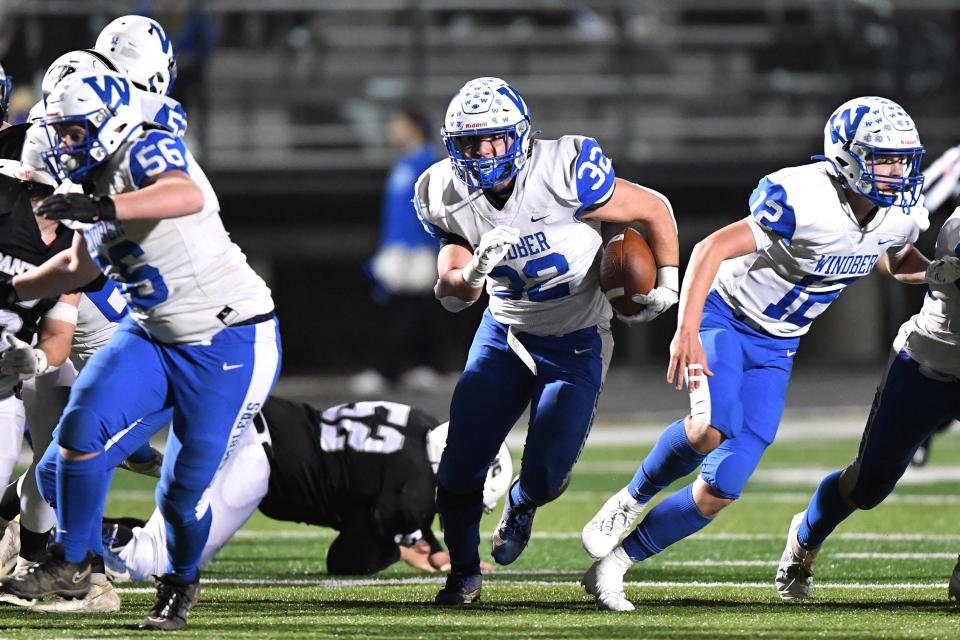 Windber's Lucas Oleksa (32) finds room to run against Northern Bedford County, between the blocks of Mason Horner (56) and Tanner Barkley (12) during the District 5 Class 1A football championship, Nov. 9, in Somerset.