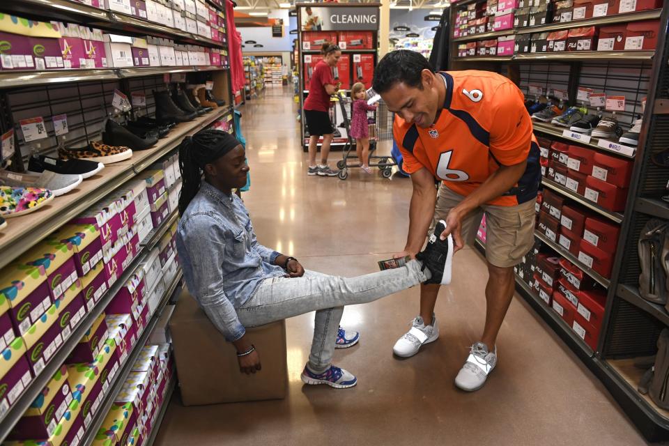 <p>Denver Broncos quarterback Mark Sanchez, left, helps Tonetra Lighthill, right, find the perfect fit on a pair of shoes as they shop at King Soopers Marketplace on July 25, 2016 in Parker, Colorado. </p>