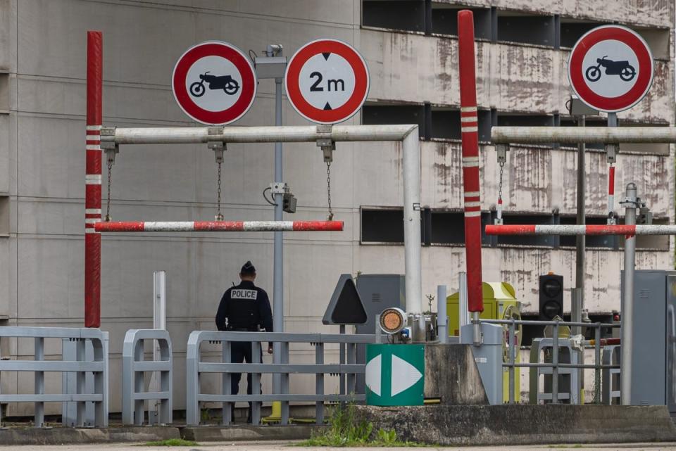 Police officers stand guard at the tollbooth which remains closed after Tuesday morning’s ambush (EPA)