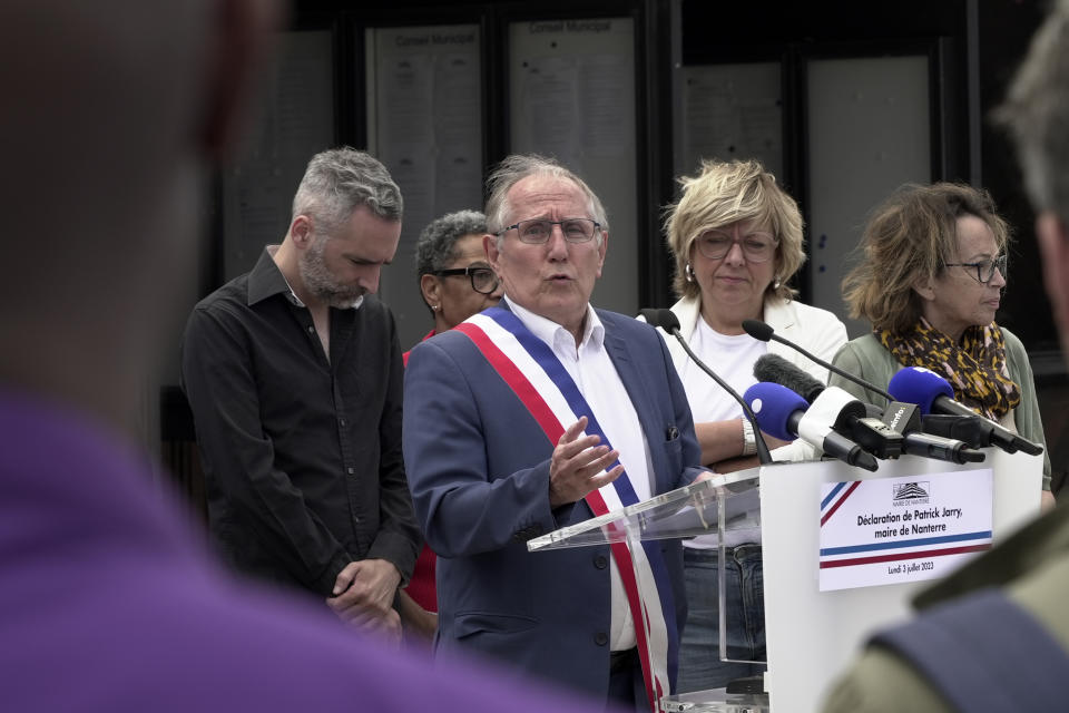 Nanterre mayor Patrick Jarry speaks outside the city hall Monday, July 3, 2023 in Paris suburb Nanterre, during a rally in a show of solidarity with the mayor of the Paris suburb of L'Hay-les-Roses after a burning car struck his home. Unrest across France sparked by the police shooting of a 17-year-old appeared to slow on its sixth night, but still public buildings, cars and municipal trash cans were targeted nationwide by fires and vandalism overnight into Monday. (AP Photo/Nicolas Garriga)