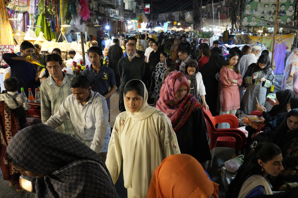 Families visit a market to buy costume jewelry and other items in preparation for the upcoming Eid al-Fitr celebrations at a market in Lahore, Pakistan, Monday, April 8, 2024. Eid al-Fitr marks the end of the Islamic holy month of Ramadan. (AP Photo/K.M. Chaudary)