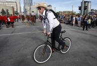 A cowboy on a bicycle during the Calgary Stampede parade in Calgary, Friday, July 8, 2016. THE CANADIAN PRESS/Jeff McIntosh