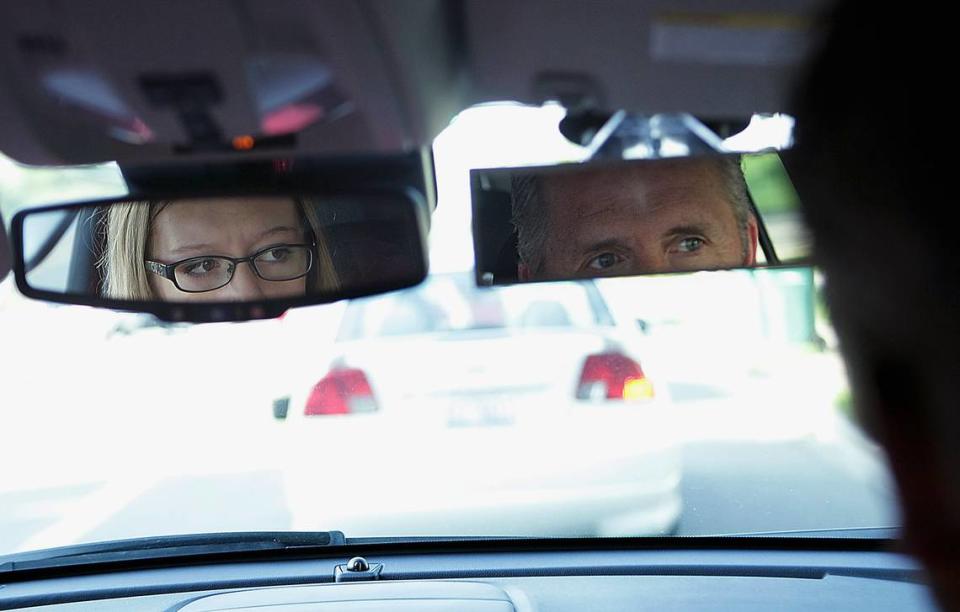 In this June 27, 2014 photo, DeKalb High School sophomore Chloe O’Dell, 15, checks her mirror at a stop during her driving time with driver education instructor John Cordes, right, in DeKalb, Ill. (AP Photo/Daily Chronicle, Danielle Guerra) MANDATORY CREDIT