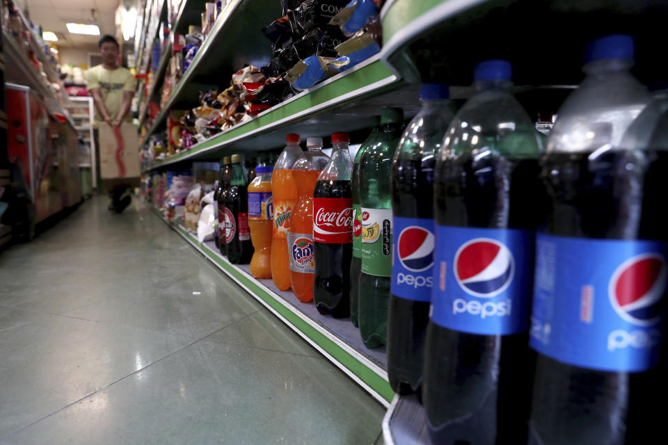 Bottles of Pepsi and Coca-Cola are displayed in a grocery store in downtown Tehran, Iran, Wednesday, July 10, 2019. Whether at upscale restaurants or corner stores, American brands like Coca-Cola and Pepsi can be seen throughout Iran despite the heightened tensions between the two countries. U.S. sanctions have taken a heavy toll, but Western food, movies, music and clothing are still widely available. (AP Photo/Ebrahim Noroozi)