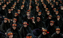 <p>A woman raises a picture of Ayatollah Khamenei, Iranian supreme leader, as women members of Hezbollah gather during the announcement of the start of the Central Council Ashura for the month of Muharram 1438 AH forum, during a private ceremony attended by hundreds of servants of Imam Hussein, where they sang and shouted in the declaration of the opening ceremony beginning Ashura in the southern suburbs of Beirut, Lebanon, Oct. 1, 2016. Shiite Muslims celebrate Ashura Day in the Islamic month of Muharram to commemorate the martyrdom of Imam Hussein, a grandson of the Prophet Muhammad, in the Iraqi city of Karbala in the seventh century. (Photo: NABIL MOUNZER/EPA)</p>