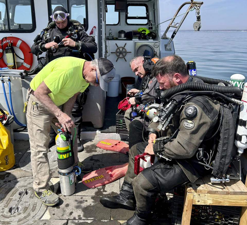 This photo, provided by Shoreline Diving Services, shows the team preparing to dive the wreck of the 92-foot attack submarine Defender, Friday, April 14, 2023, that was scuttled by the Army Corp of Engineers in 1946. The Defender was found Sunday, April 23, 2023 by a dive team led by Richard Simon, a commercial diver from Coventry, Connecticut. (Jennifer Sellitti/Shoreline Diving Services via AP)