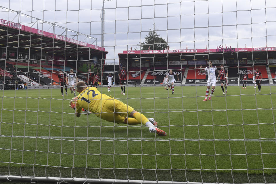 Bournemouth's goalkeeper Aaron Ramsdale saves a penalty during the English Premier League soccer match between Bournemouth and Southampton, at the Vitality Stadium in Bournemouth, England, Sunday, July 19, 2020. (Mike Hewitt/Pool Photo via AP)