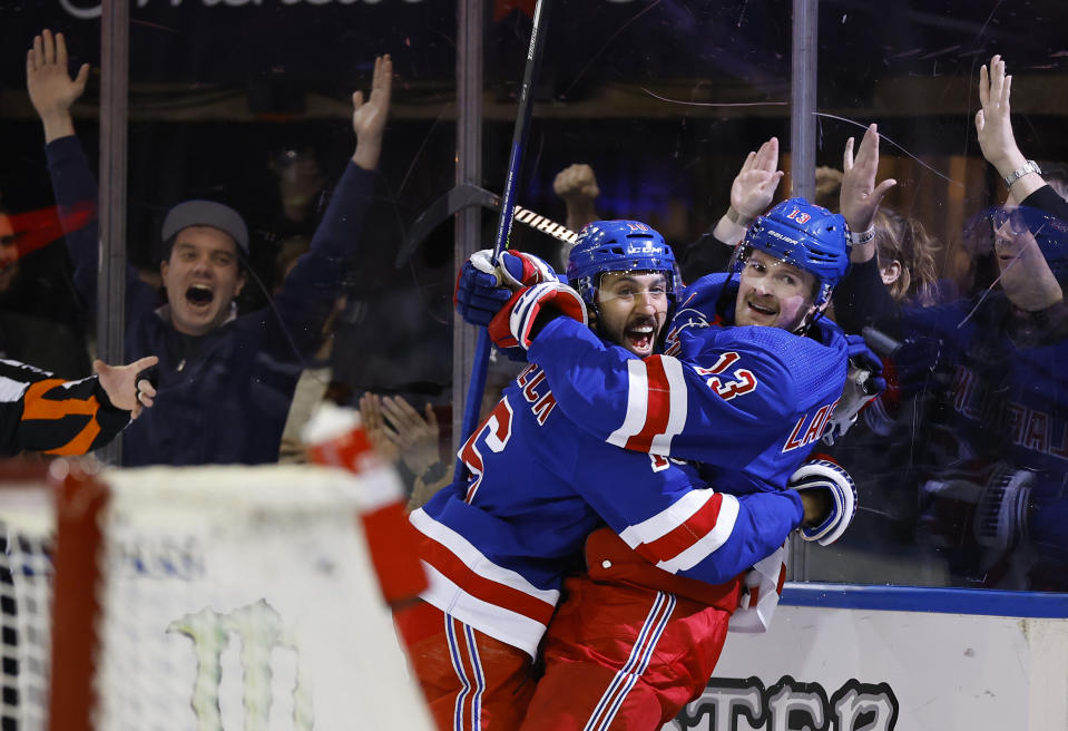 New York Rangers left wing Alexis Lafreniere celebrates with center Vincent Trocheck, left, after scoring a goal against the Columbus Blue Jackets during the second period of an NHL hockey game, Sunday, Nov. 12, 2023, in New York. (AP Photo/Noah K. Murray)