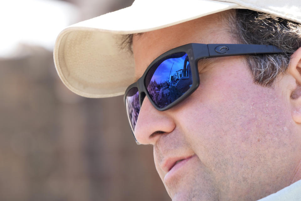 Charlie Weissinger's sunglasses reflect the remnants left from a March 24 tornado, that hit The Chapel of The Cross Episcopal Church in Rolling Fork, Miss., on March 29, 2023, as he joined other church members in salvaging some church property. The Weissinger family roots run deep in the 99-year old church and largely farming community and he expects his family will join members in rebuilding the church and repairing the neighboring family home which was damaged by the killer tornado. (AP Photo/Rogelio V. Solis)