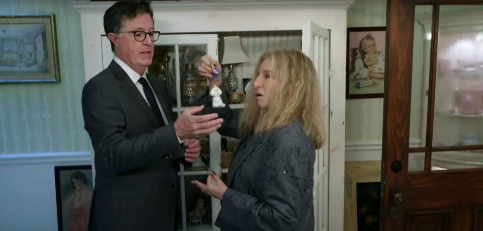 Stephen Colbert and Barbra Streisand looking at ornaments.