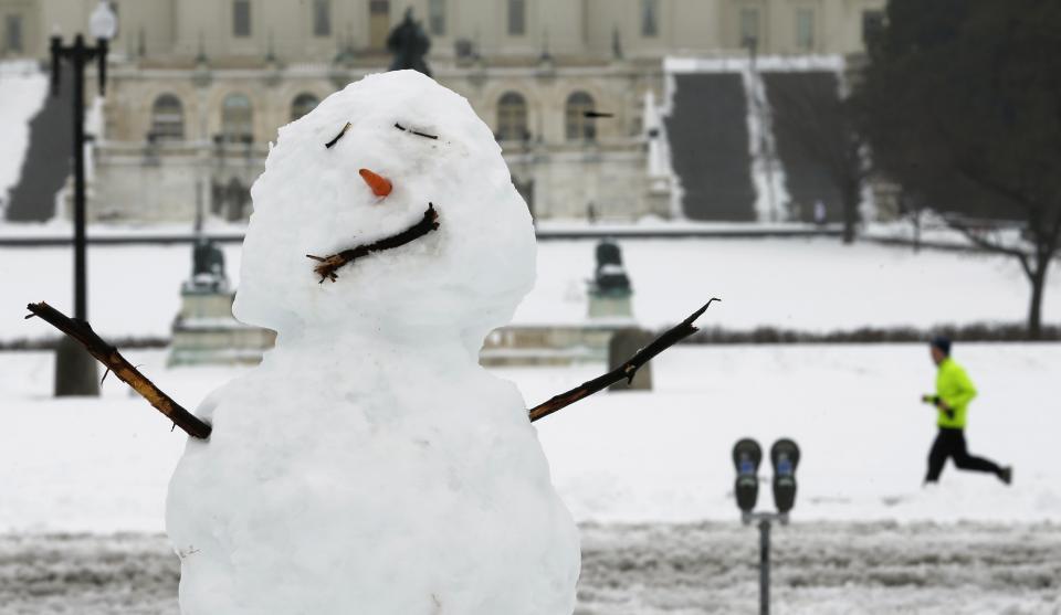 Jogger passes a snowman near the Capitol in Washington