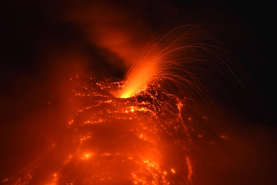 <p>A photo taken on Jan. 25, 2018 from the city of Legazpi, Albay province, south of Manila, shows a fiery fountaining during an eruption of the Mayon volcano as it emits molten lava. (Photo: Ted Aljibe/AFP/Getty Images) </p>