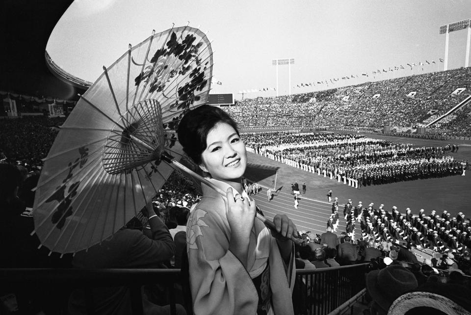 <p>Yuko Shibayama of Tokyo wears traditional garb to watch the colorful opening ceremonies of the 18th Olympiad at the National Stadium.</p>