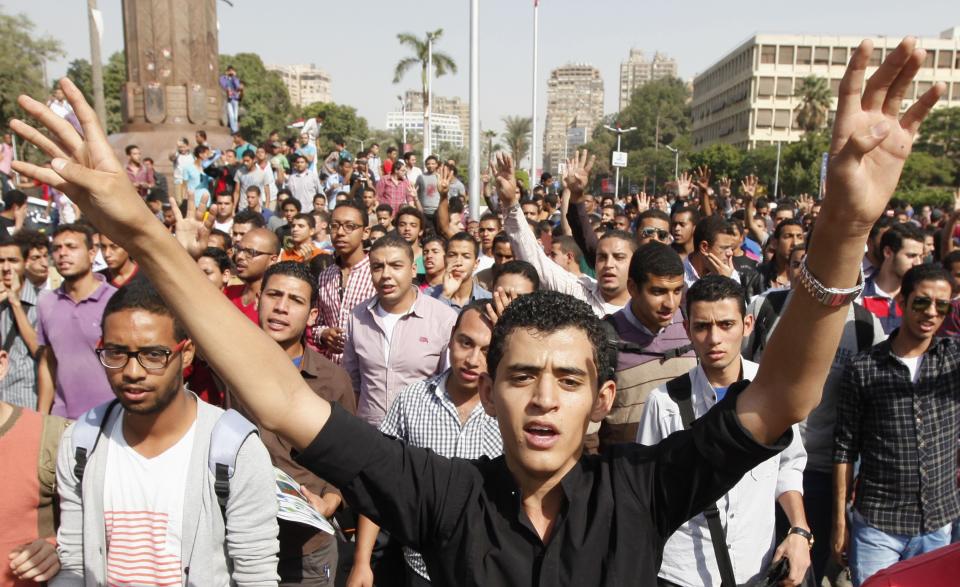 Cairo university students and members of Muslim Brotherhood shout slogans against military in front of Cairo University in Cairo