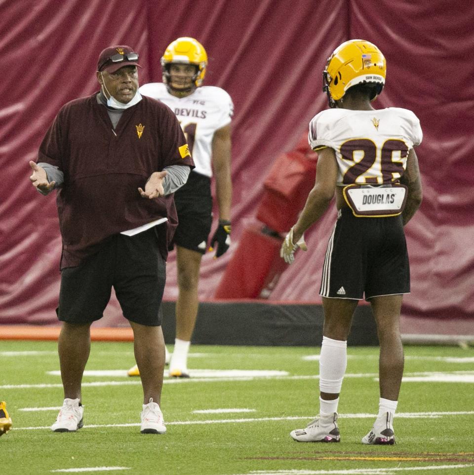 ASU interim defensive back coach Donnie Henderson alongside ASU defensive back T Lee during an ASU football practice at the Kajikawa Practice Facility in Tempe on August 16, 2021.