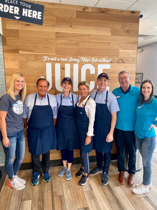 Dougal Nelson (second from right), CEO of Junior Achievement of the Heartland, visits a Jersey Mike’s location in March 2023 during the Month of Giving.