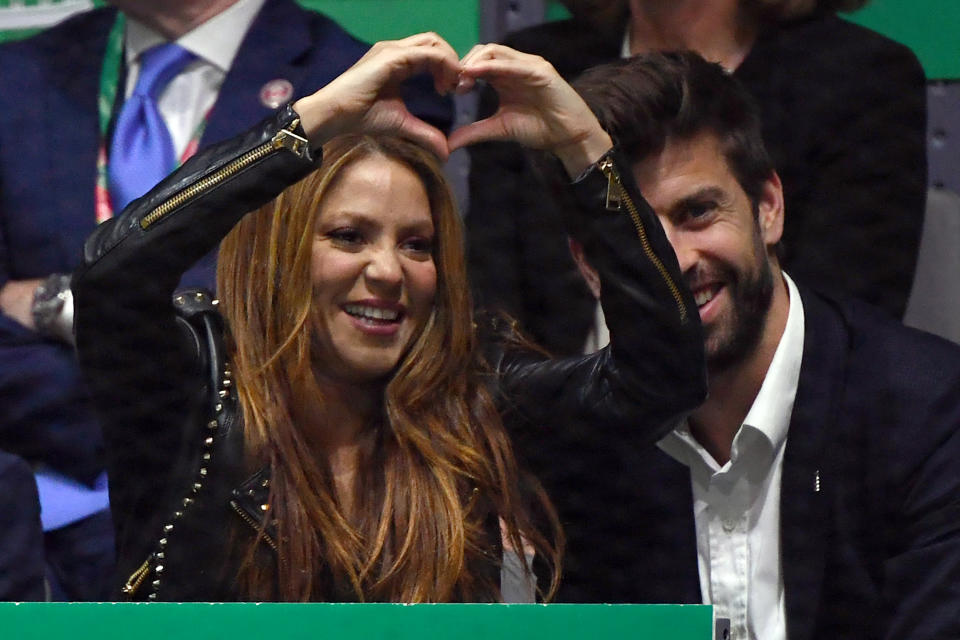 Colombian singer Shakira signs a heart beside her husband Barcelona's Spanish defender and Kosmos president Gerard Pique as they watch Spain's Rafael Nadal playing Canada's Denis Shapovalov during the final singles tennis match between Canada and Spain at the Davis Cup Madrid Finals 2019 in Madrid on November 24, 2019. (Photo by GABRIEL BOUYS / AFP) (Photo by GABRIEL BOUYS/AFP via Getty Images)