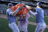 Kansas City Royals' Michael Massey is doused by Bobby Witt Jr., left, and MJ Melendez (1) after their baseball game against the Seattle Mariners Sunday, Sept. 25, 2022, in Kansas City, Mo. The Royals won 13-12. (AP Photo/Charlie Riedel)