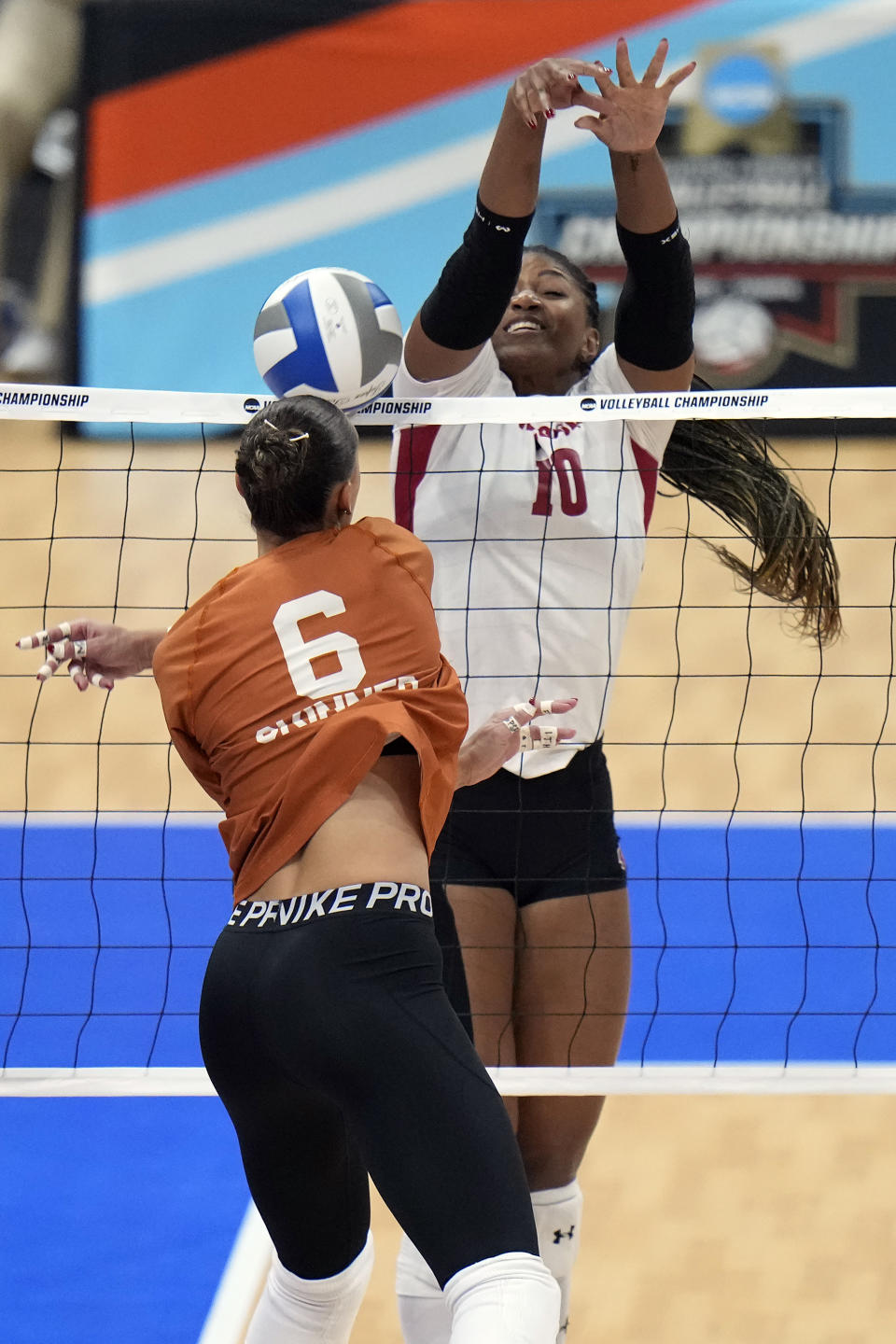 Wisconsin's Devyn Robinson (10) blocks a shot by Texas's Madisen Skinner (6) during a semifinal match in the NCAA Division I women's college volleyball tournament Thursday, Dec. 14, 2023, in Tampa, Fla. (AP Photo/Chris O'Meara)