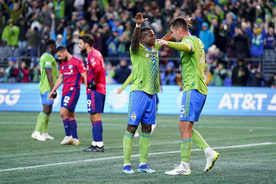 Seattle Sounders defender Nouhou Tolo, front left, reaches out to hug defender Jackson Ragen, right, after the team's 1-0 win over FC Dallas in Game 3 of an MLS first-round playoff soccer series, Friday, Nov. 10, 2023, in Seattle. (AP Photo/Lindsey Wasson)