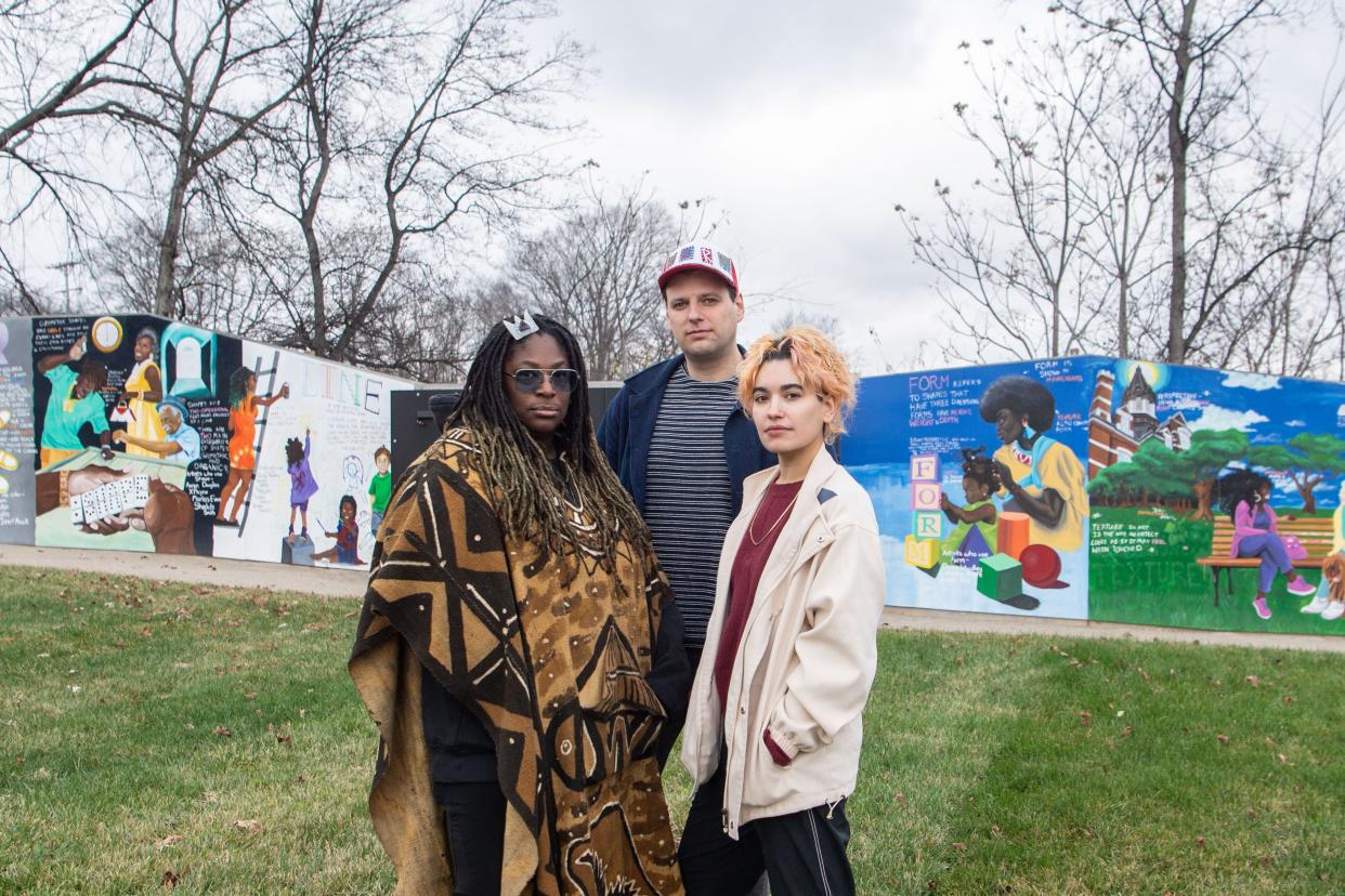 Elisheba Israel Mrozik, Robert Jones and Bexx Chin stand at the Kossie Gardner Sr. Park in Nashville, Tenn., Friday, Dec. 29, 2023. Mrozik painted the mural in the background and is the president of North Nashville Arts Coalition. Jones and Chin work at Overton Arts at the 100 Taylor Arts Collective. Metro Arts reduced funding for the coalition and collective this year.