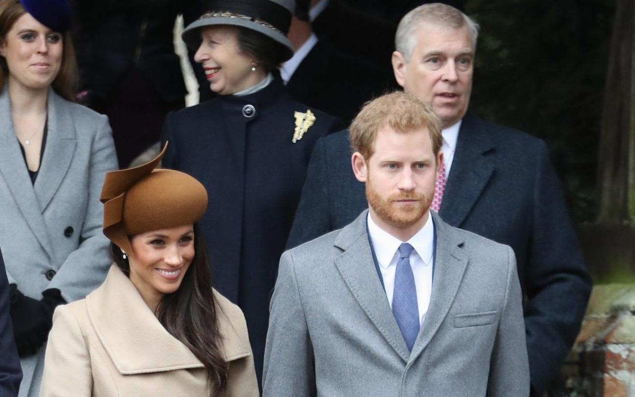 The Duke and Duchess of Sussex stand in front of Prince Andrew - Chris Jackson