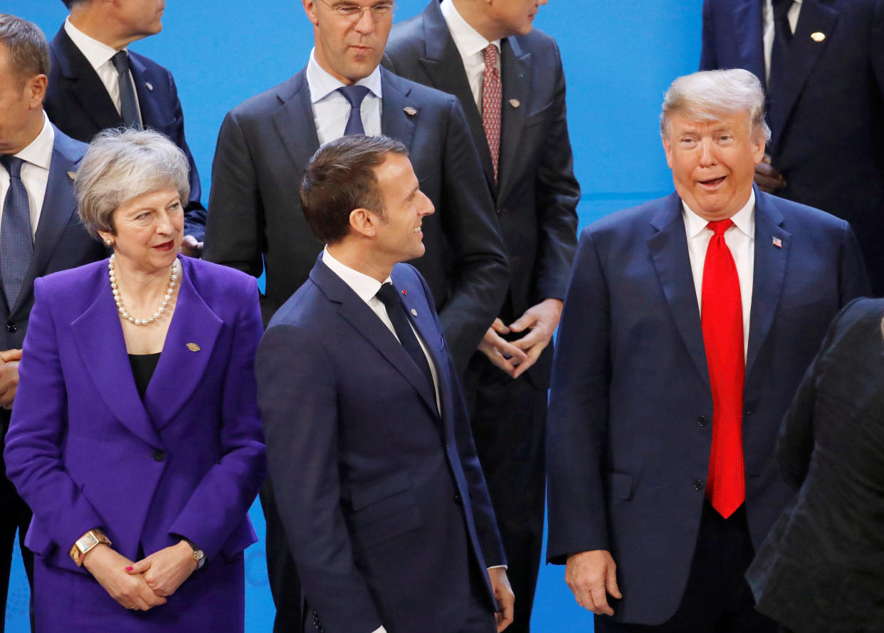 Britain’s Prime Minister Theresa May, French President Emmanuel Macron and U.S. President Donald Trump are seen before the family photo during the G20 summit. Photo: REUTERS/Andres Martinez Casares/Pool