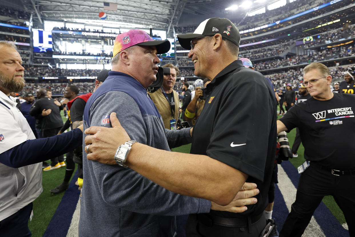 Dallas Cowboys head coach Mike McCarthy speaks with Washington Commanders head coach Ron Rivera after an NFL football game, Sunday, Oct. 2, 2022, in Arlington. (AP Photo/Tyler Kaufman)