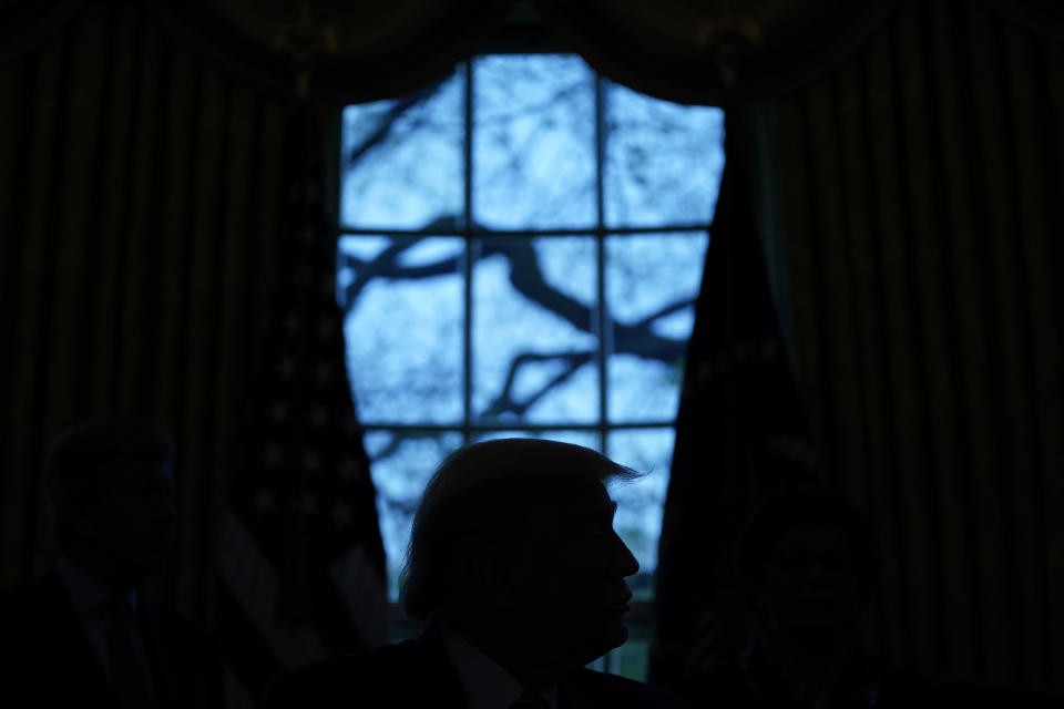 FILE - In this April 24, 2020, file photo President Donald Trump looks on during the signing of a coronavirus aid package to direct funds to small businesses, hospitals, and testing, in the Oval Office of the White House in Washington. (AP Photo/Evan Vucci, File)