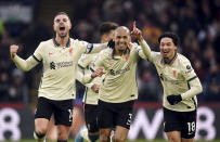 Liverpool's Fabinho celebrates scoring his side's third goal of the game with team-mates Jordan Henderson, left, and Takumi Minamino during the English Premier League soccer match between Crystal Palace and Liverpool at Selhurst Park, London, Sunday, Jan. 23, 2022. (Adam Davy/PA via AP)