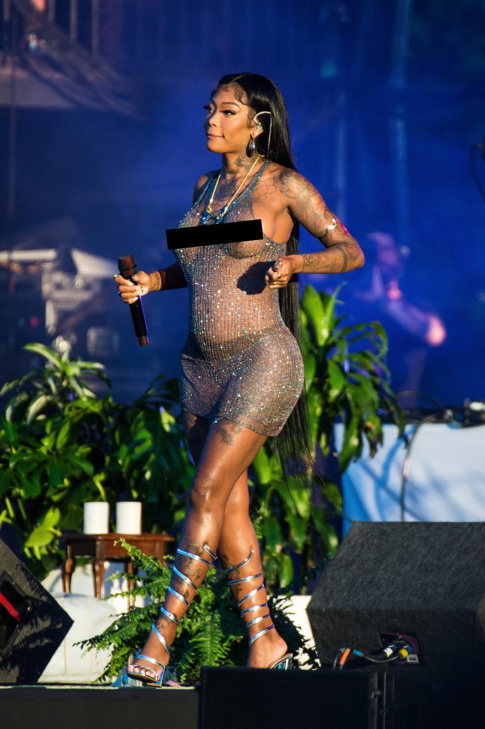 Summer Walker performs in a silver dress at Wireless Festival