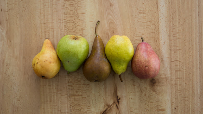different colored pears on wood table