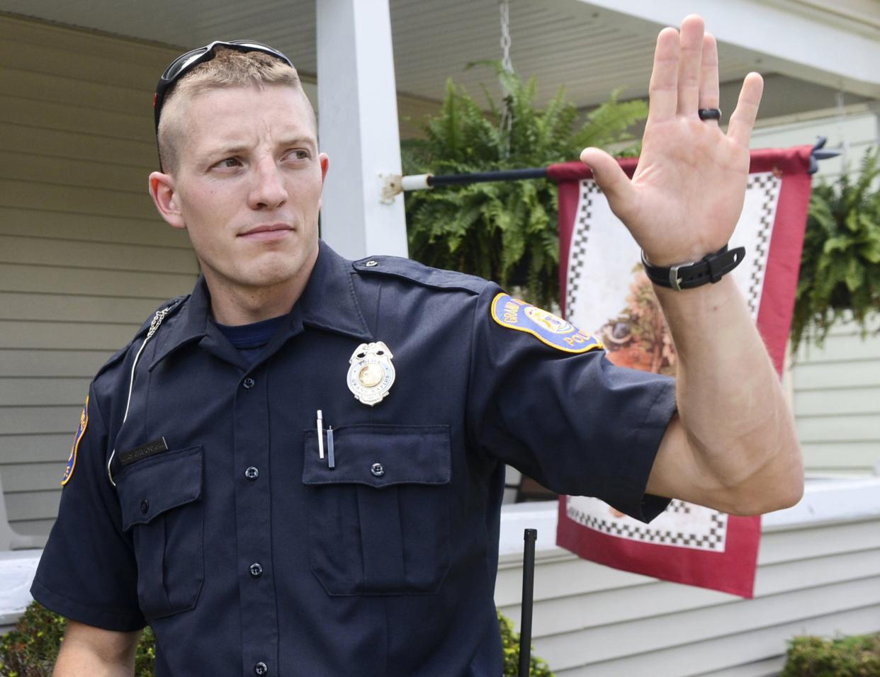 Grand Rapids Police Officer Christopher Schurr stops to talk with a resident, Wednesday, August 12, 2015, in Grand Rapids, Mich. 