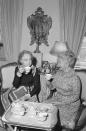 <p>Actress Lillian Gish invites friend and fellow actress Helen Hayes to tea in her home in 1977. Gish lived in many of the city's iconic hotels before moving into her late mother's apartment in 1948.</p>