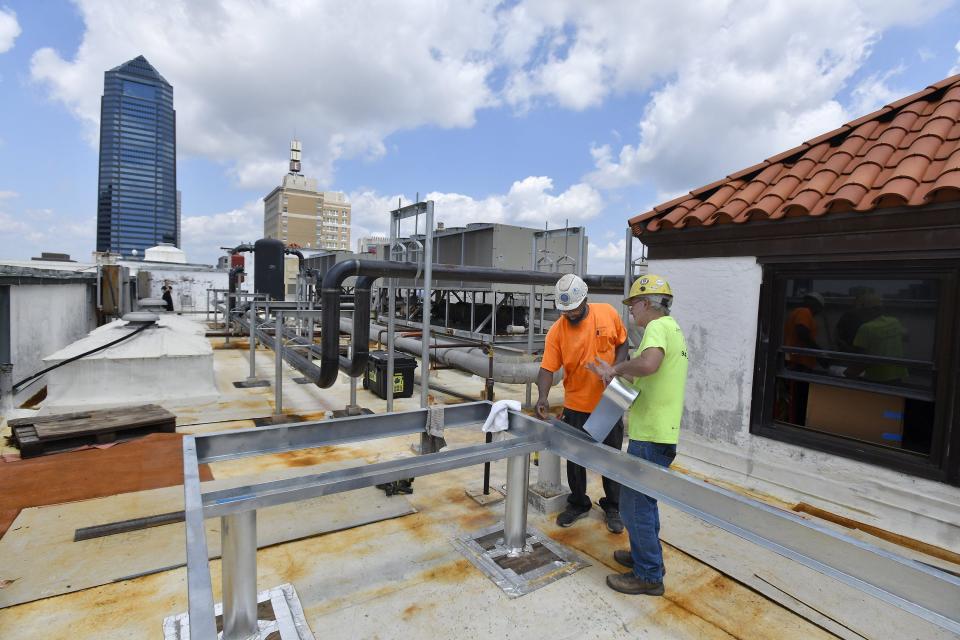 Workers prepare an elevated pad on the roof of the Florida Theatre to hold a new emergency generator for the building Tuesday, June 27, 2023. The theater is preparing to close for nearly four months of renovation projects to bring the almost 100-year-old building back to its vintage glory.