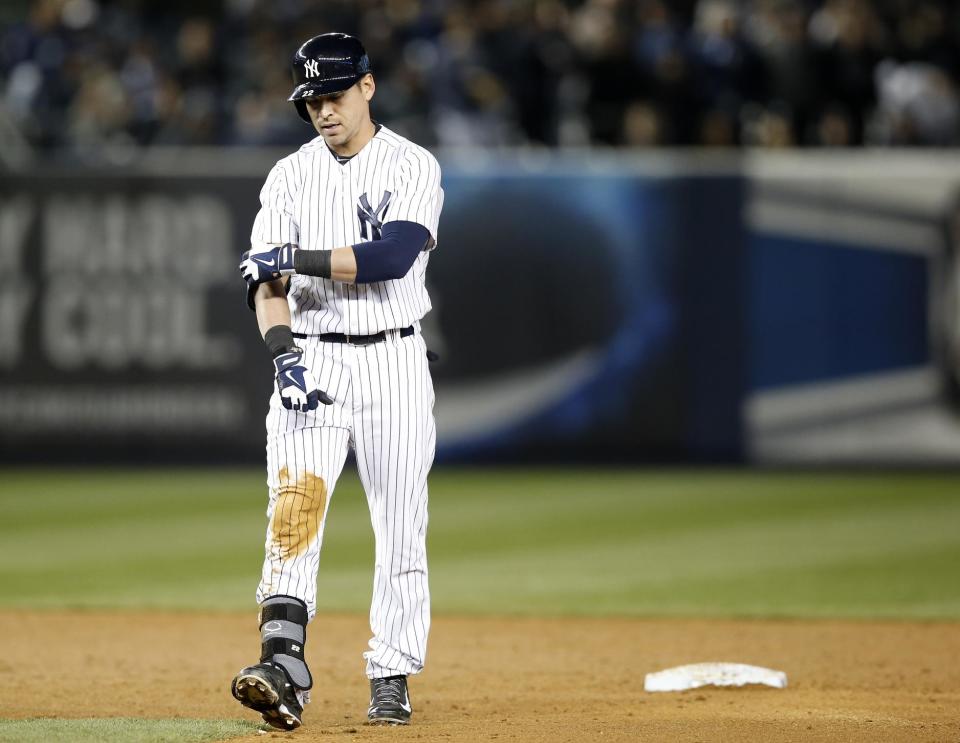 New York Yankees' Jacoby Ellsbury walks off after he was put out trying to stretch a fifth-inning RBI-single into a double in a baseball game against the Boston Red Sox at Yankee Stadium in New York, Thursday, April 10, 2014. (AP Photo/Kathy Willens)