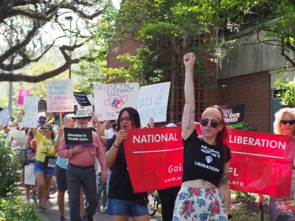 Abortion supporters march down University Avenue chanting "Don't like abortion? Don't get one."