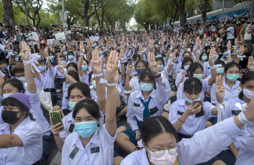 FILE - In this Sept. 5, 2020, file photo, high school students salute with three-fingers, symbol of resistance during a protest rally in Bangkok, Thailand. Fed up with an archaic educational system and enraged by the military's efforts to keep control over their nation, a student-led campaign has shaken Thailand’s ruling establishment with the most significant campaign for political change in years. (AP Photo/Gemunu Amarasinghe, File)