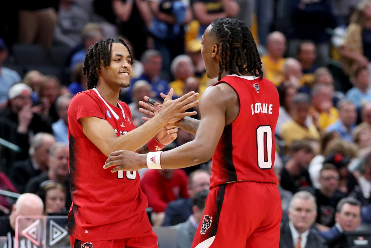 North Carolina State guard Breon Pass (10) celebrates with guard DJ Horne (0) during its game against Marquette in the semifinal of the South Regional of the 2024 NCAA men's tournament at American Airlines Center.