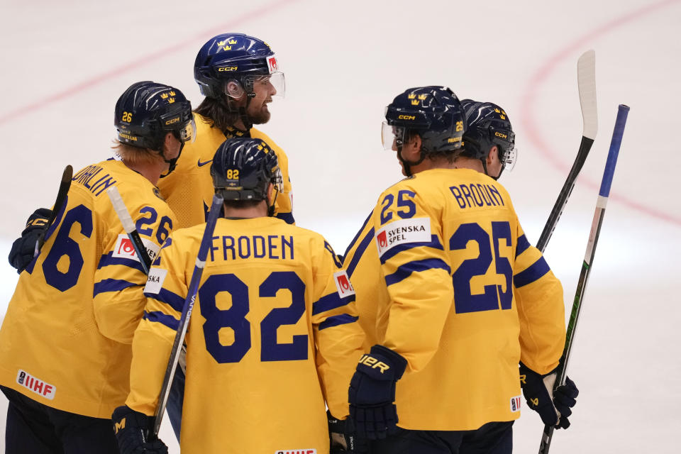 Sweden's Carl Grundstrom celebrates with teammates after scoring his side's fourth goal during the preliminary round match between Germany and Sweden at the Ice Hockey World Championships in Ostrava, Czech Republic, Monday, May 13, 2024. (AP Photo/Darko Vojinovic)