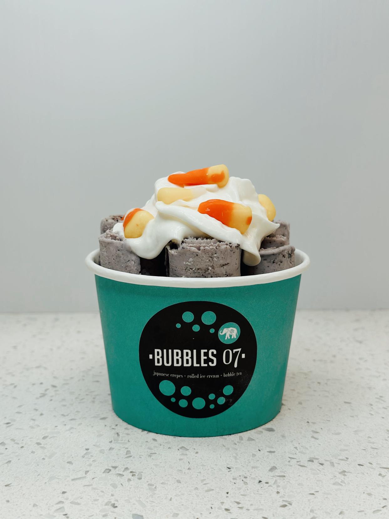 Monster Mash rolled ice cream (tarro Oreo vanilla rolled ice cream with whipped cream and candy corn) from Bubbles07 locations.